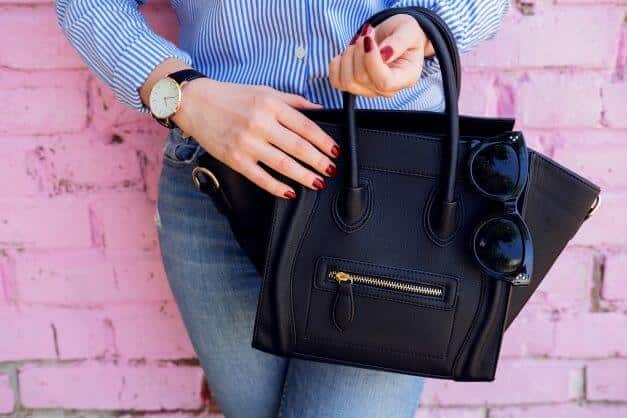 black leather bag and blue jeans