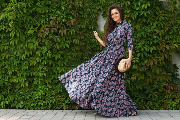 A woman in a colourful maxi dress