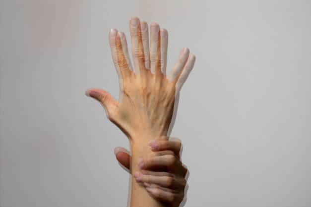 A blurred hand giving the impression of double vision