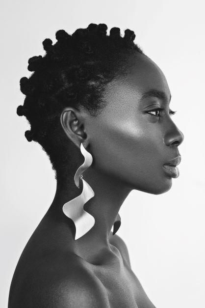 Woman wearing long swirly earrings