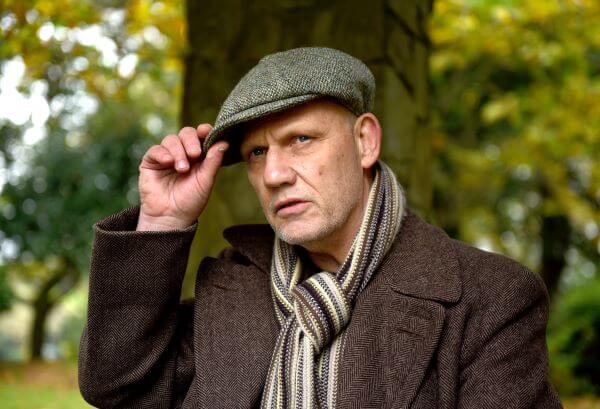 Older man in flat cap