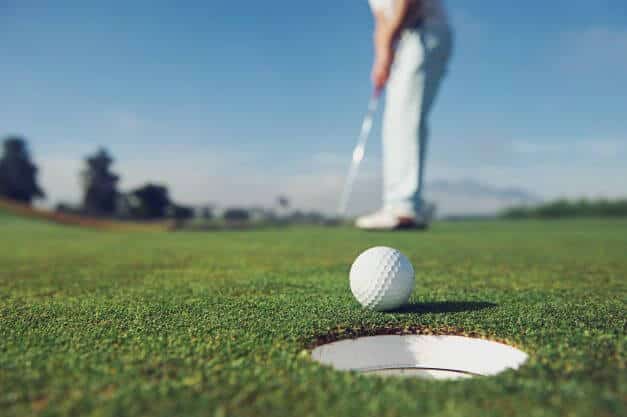 man putting in golf