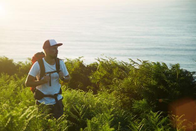man walking wearing trucker hat