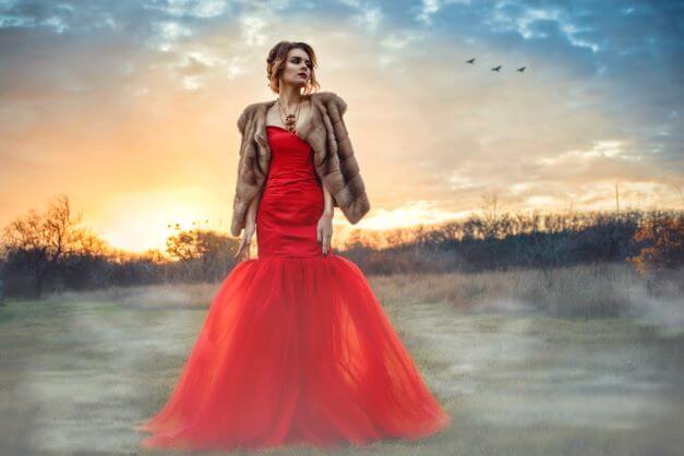 Woman in red ball gown who has accessorised