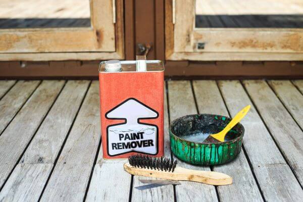 A can of paint stripper and brushes