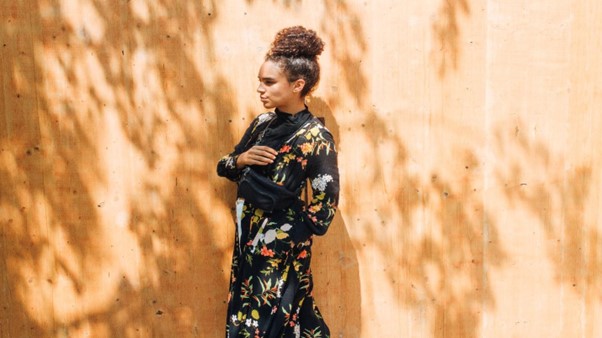 Woman in dark floral dress