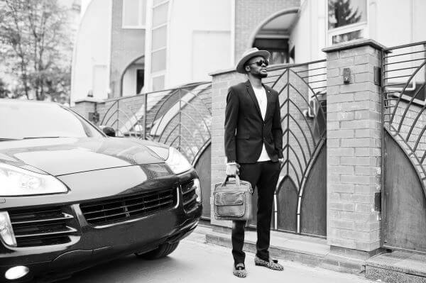 A dark suit with hat and leopard print shoes