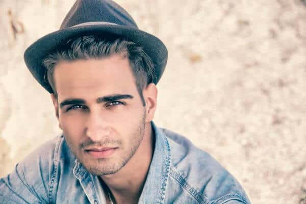 Young man wearing a dark trilby hat