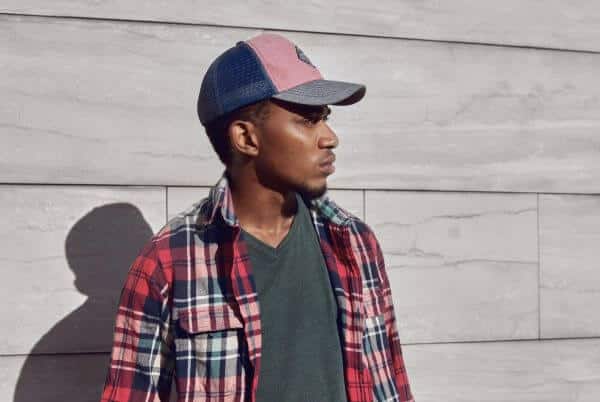 Man wearing a blue and pink trucker hats