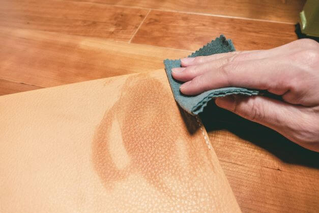 wiping leather handbag with damp cloth