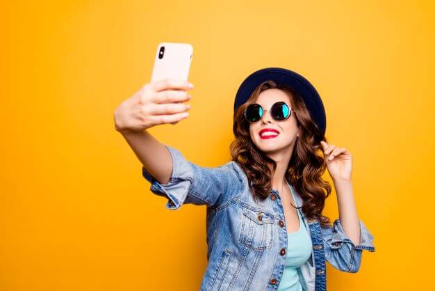 woman in glasses taking selfie