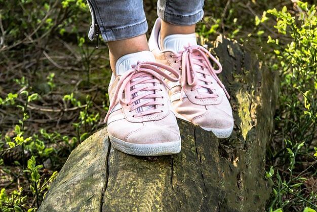 woman in shoes on log