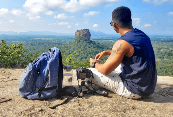 Man sitting on top of mountain
